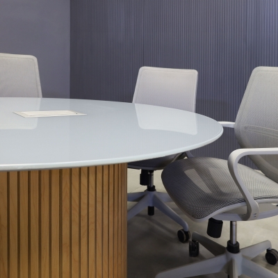 48-inch Omaha Round Conference Table in 1/2-inch light gray tempered glass top, and white oak tambour base, with silver MX3 power box.