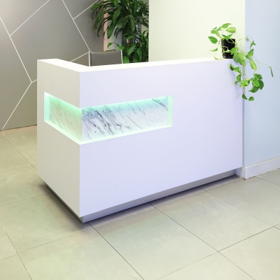 60-inch Manhattan L-Shape Custom Reception Desk in calcutta stone pvc laminate accent panel, and white matte laminate main desk. Brushed aluminum toe-kick, with multi-colored LED, shown here.
