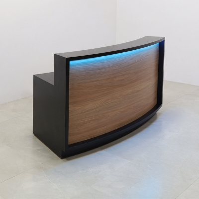 72-inch Seattle X2 Reception Desk in Black Matte Laminate Desk and Uptown Walnut Front Panel, with colored LED, shown here.
