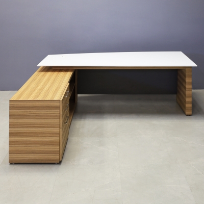 84-inch Avenue Curved Executive Desk with Credenza in 1/2-inch white solid engineered surface top, zebrawood veneer credenza & leg, and storm gray matte laminate privacy panel.