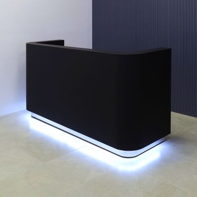 90-inch Nola Custom Reception Desk in black traceless laminate main desk, brushed aluminum toe-kick, and warm white LED.