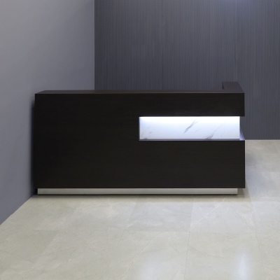 90-inch Manhattan L-Shape Custom Reception Desk in calcutta stone PVC accent pane, and ebony recon matte laminate main desk, with gold aluminum toe-kick, and warm white LED, shown here.