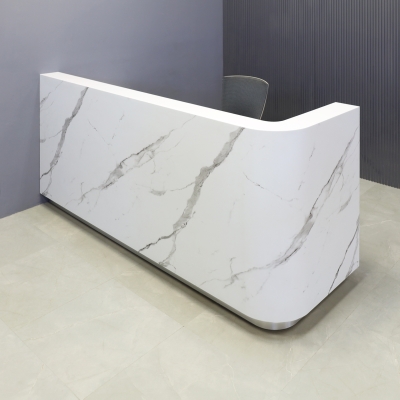 90-inch Nola L-Shape Custom Reception Desk with the l-panel on the right side. The main desk is covered in calcutta stone PVC, and the toe-kick in brushed aluminum.