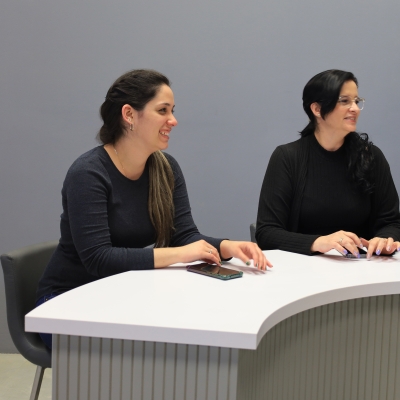 90-inch Modern Custom Podcast Table in white matte laminate top, fog gray tambour front side, and white matte laminate inside.