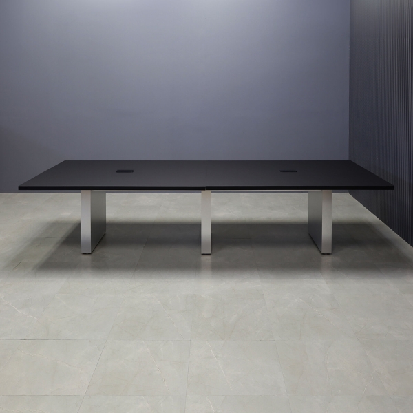 144-inch Newton Rectangular Conference Table in black traceless laminate top and brushed aluminum laminate standard base, with two black power boxes, shown here.