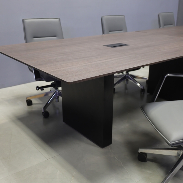 144-inch Aurora Rectangular Conference Table in 1/2-inch Gray oak engineered surface top, black matte laminate standard base, and 2 black MX3 power boxes.