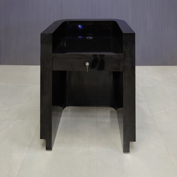 32-inch Nola Podium & Host Custom Desk in black gloss laminate main desk, and brushed gold toe-kick. Built-in pencil drawer with lock.