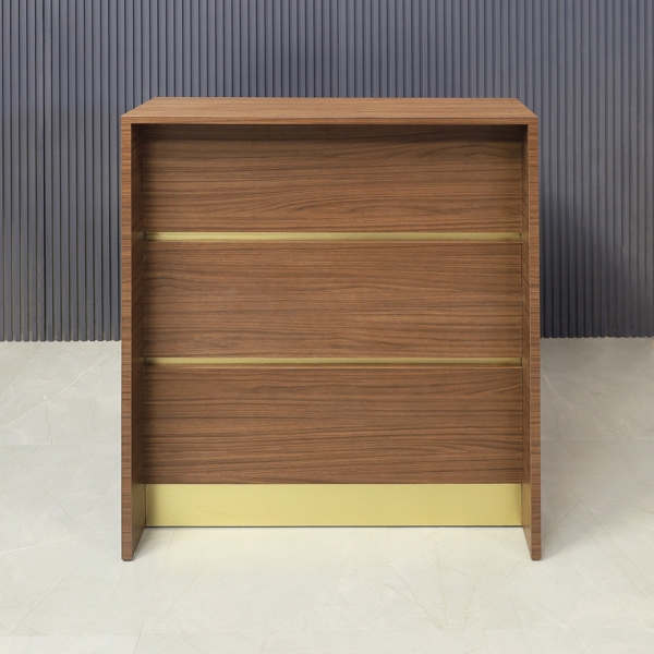 32-inch New Jersey Podium & Host Custom Reception Desk in walnut heights matte laminate main desk & front panels, and brushed gold accent & toe-kick.