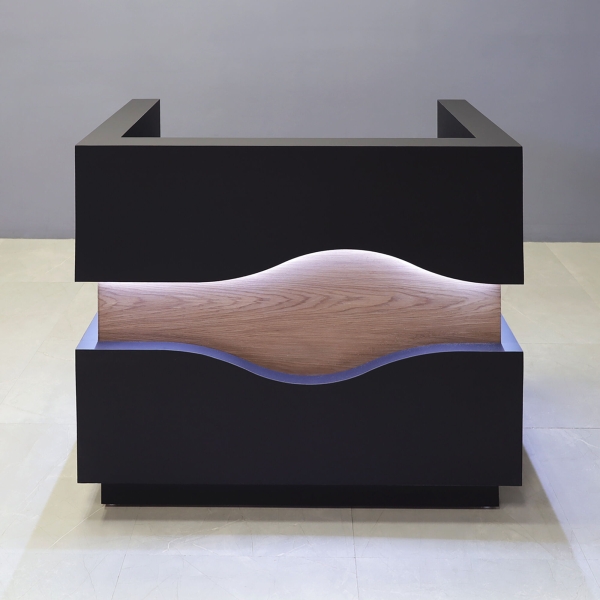 48-inch Wave Podium & Host in black traceless laminate main desk & toe-kick, and walnut veneer wave accent, with warm-white LED, shown here.
