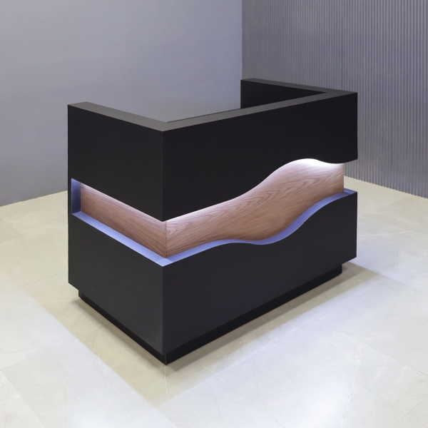 48-inch Wave Podium & Host in black traceless laminate main desk & toe-kick, walnut veneer waved accent, and warm white LED.