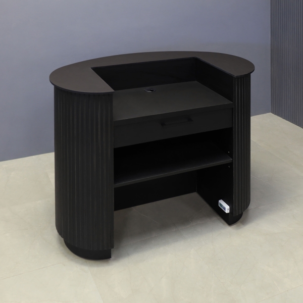 48-inch The Pill Podium & Host Custom Desk in 1/2-inch black traceless engineered surface top counter, black traceless tambour main desk, black traceless laminate workspace & toe-kick, and color changing LED. Small drawer and adjustable shelf.