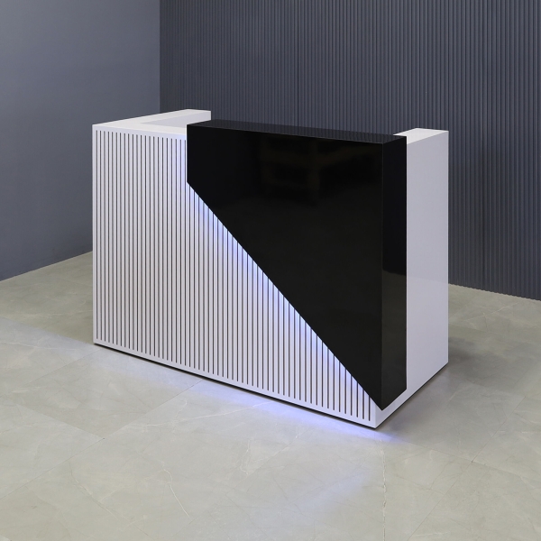 60-inch Miami Custom Reception Desk in black gloss laminate counter and white gloss laminate desk workspace and grooved front panel, with multi-colored LED, shown here.