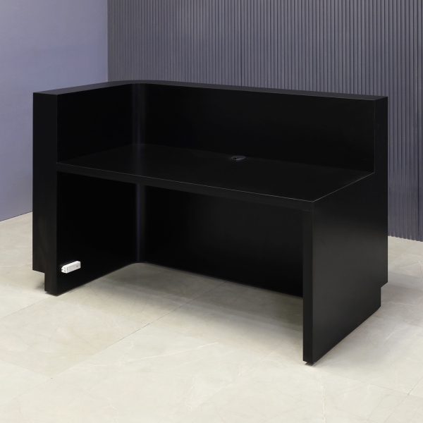 60-inch Nola L-Shape Custom Reception Desk with the l-panel on the right side. The main desk is covered in black traceless tambour, the workspace and toe-kick in black matte laminate, and comes with warm white LED.