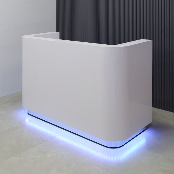 60-inch Nola Reception Desk in white gloss laminate main desk, brushed aluminum toe-kick, and color changing LED.