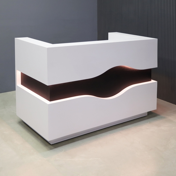 60-inch Wave Reception Desk in white matte laminate desk, counter & toe-kick, with ebony veneer wave accent front, and warm white LED, shown here.