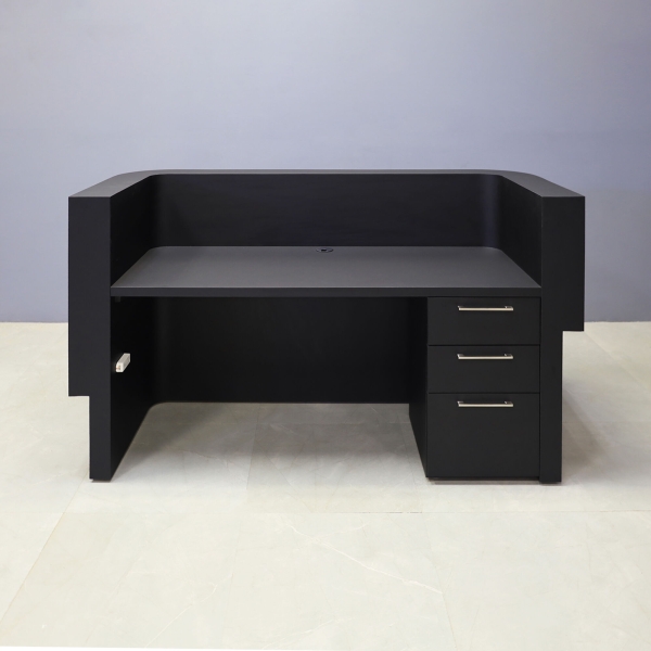 72-inch Nola Curved Custom Reception Desk in black traceless laminate counter, maple tambour bottom. Built-in storage on the right side when sitting.