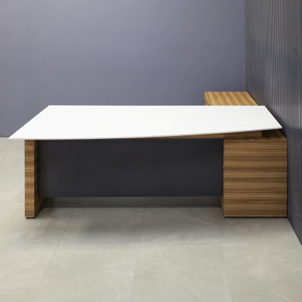 84-inch Avenue Curved Executive Desk with Credenza in 1/2-inch white solid engineered surface top, zebrawood veneer credenza & leg, and storm gray matte laminate privacy panel.