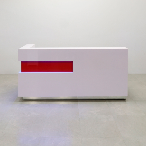 90-inch Manhattan L-Shape Custom Reception Desk in classic red gloss laminate accent panel, and white gloss laminate main desk. Brushed aluminum toe-kick, with multi-colored LED, shown here.